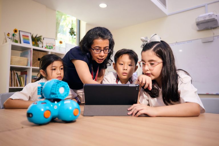 students doing robotics with teacher