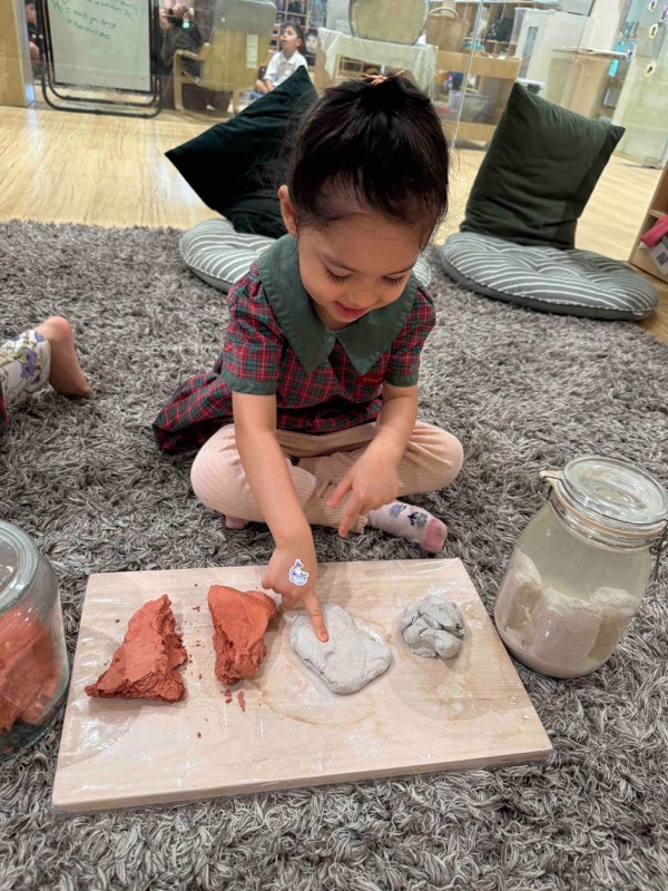 Nursery 1 children exploring clay through touch and movement
