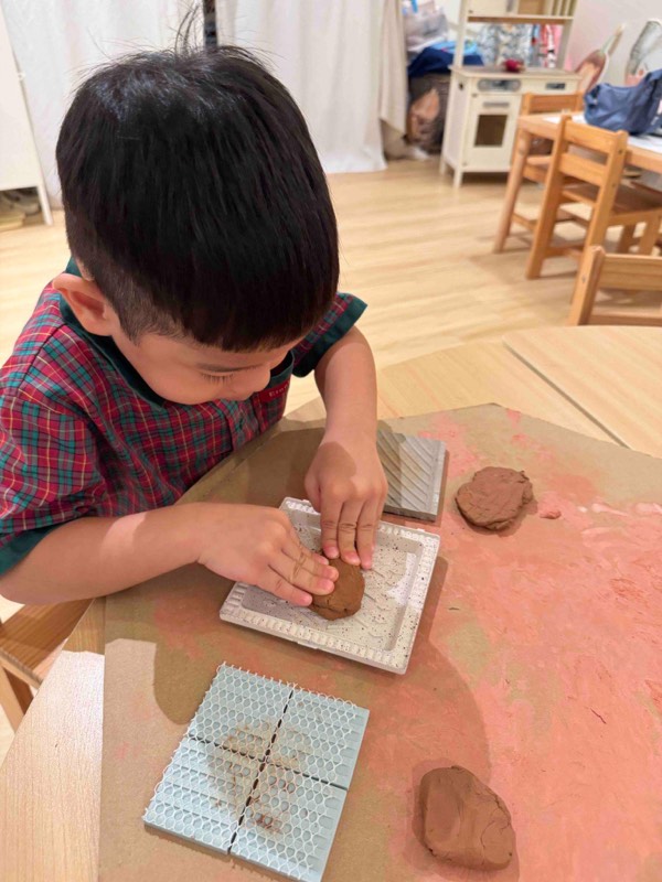 Nursery 1 children discovering textures and patterns with clay