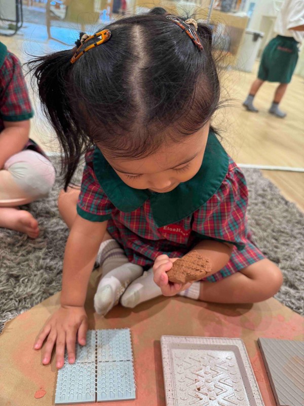 Nursery 1 children discovering textures and patterns with clay