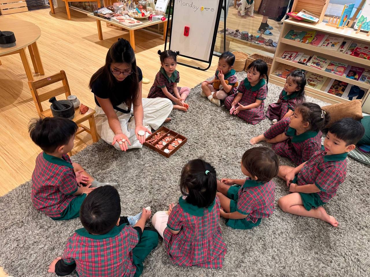 Nursery 1 children exploring how dried clay can be transformed