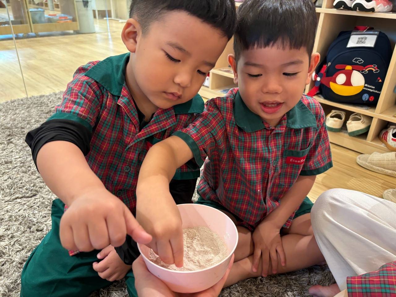 Nursery 1 children exploring how dried clay can be transformed