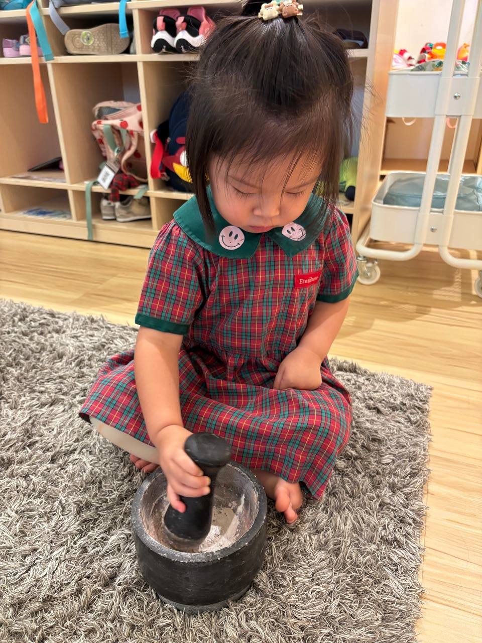 Nursery 1 children exploring how dried clay can be transformed
