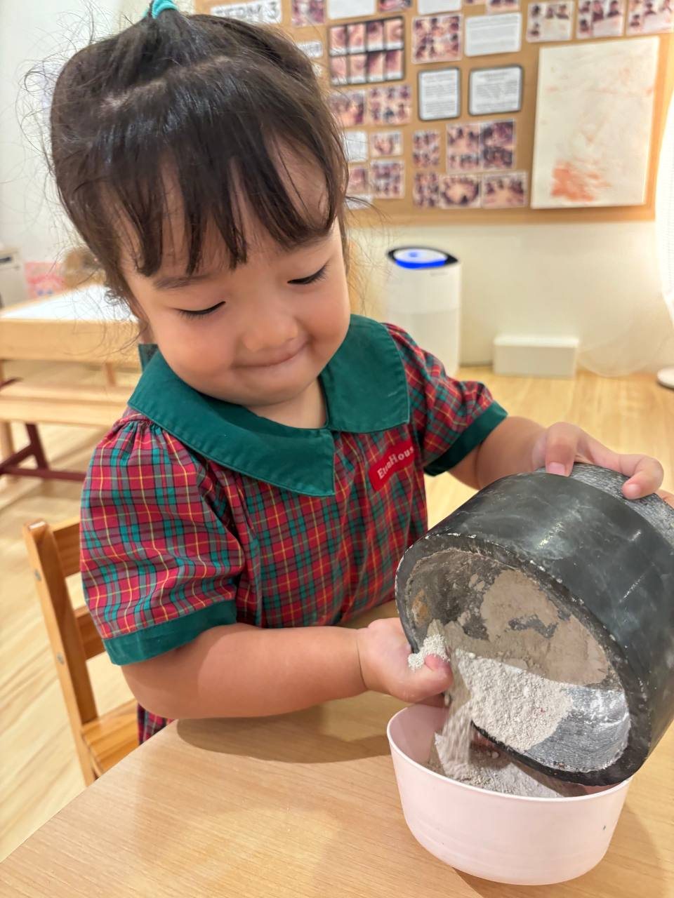 Nursery 1 children exploring how dried clay can be transformed