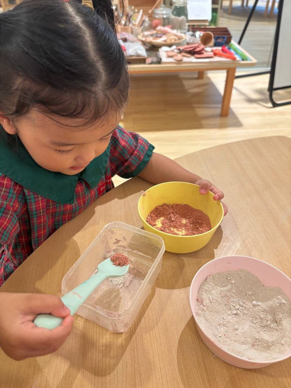 Nursery 1 children mixing clay powder and water