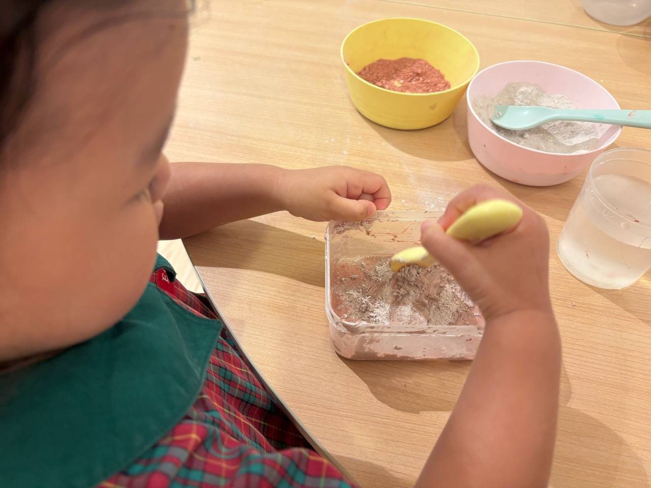 Nursery 1 children mixing clay powder and water