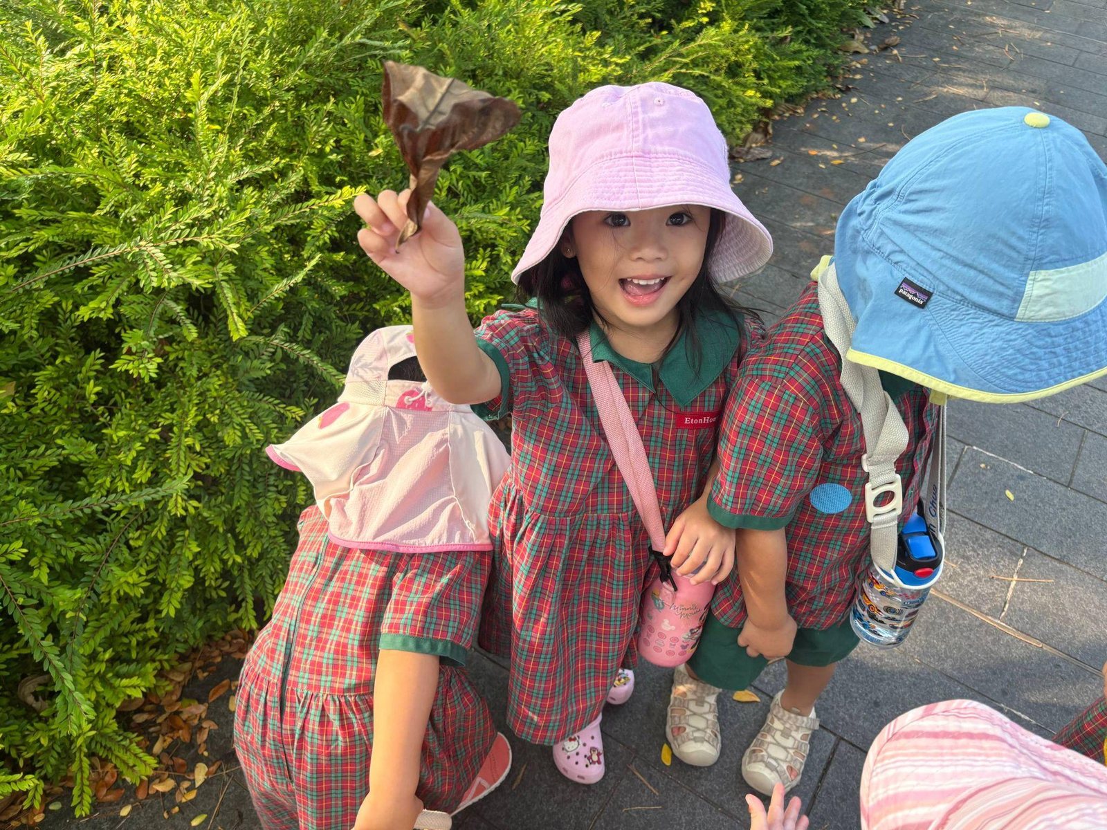 Nursery 1 children gathering natural materials outdoors
