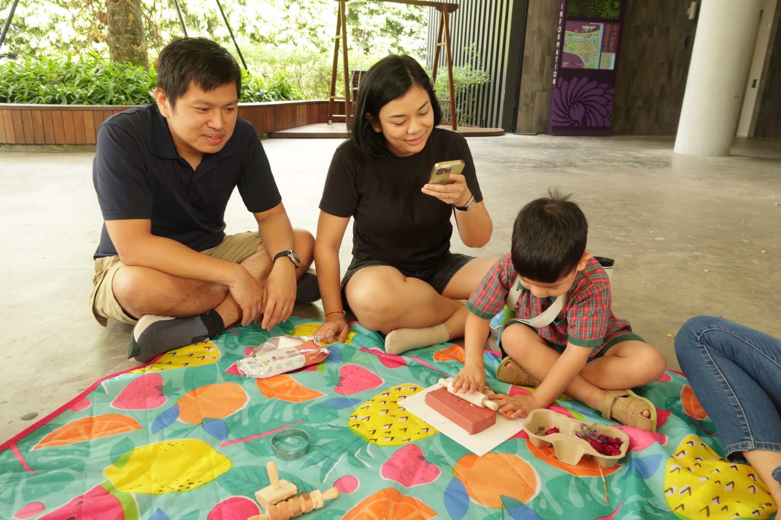 A family collaborating on an open-ended clay sculpture