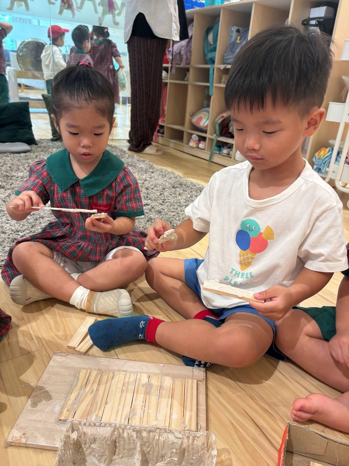 Nursery 1 children using clay slip as a connector
