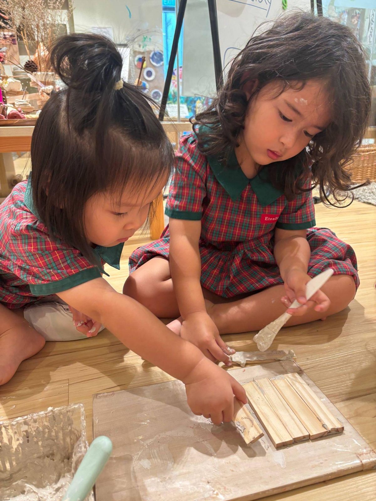 Nursery 1 children building with clay slip and wooden planks