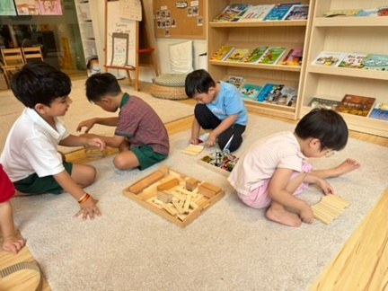 Children exploring loose parts and reusable materials together