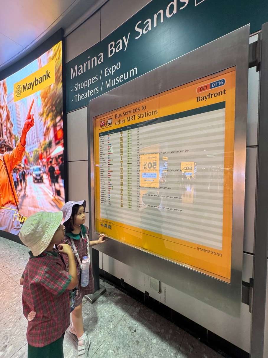 Children observing the locality map at Bayfront MRT station