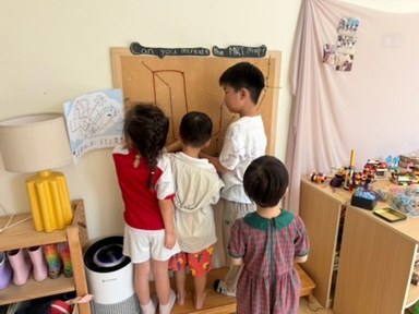 Children collaborating on a corkboard MRT map