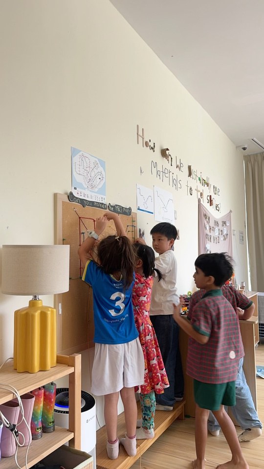 Children discussing the routes on their corkboard MRT map