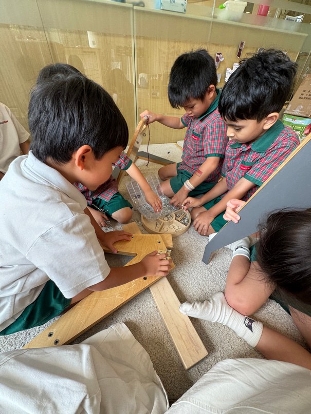 Children collaborating to construct the classroom gantry